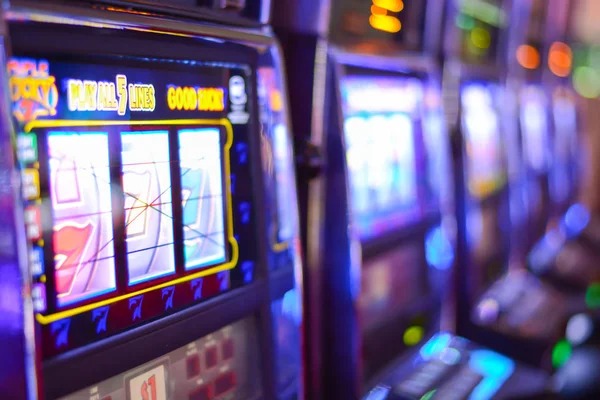Slot game interface on mobile phone showing reels and spin button